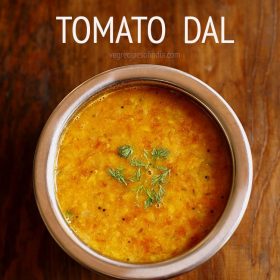 tomato pappu garnished with coriander leaves and served in a bowl with text layover.