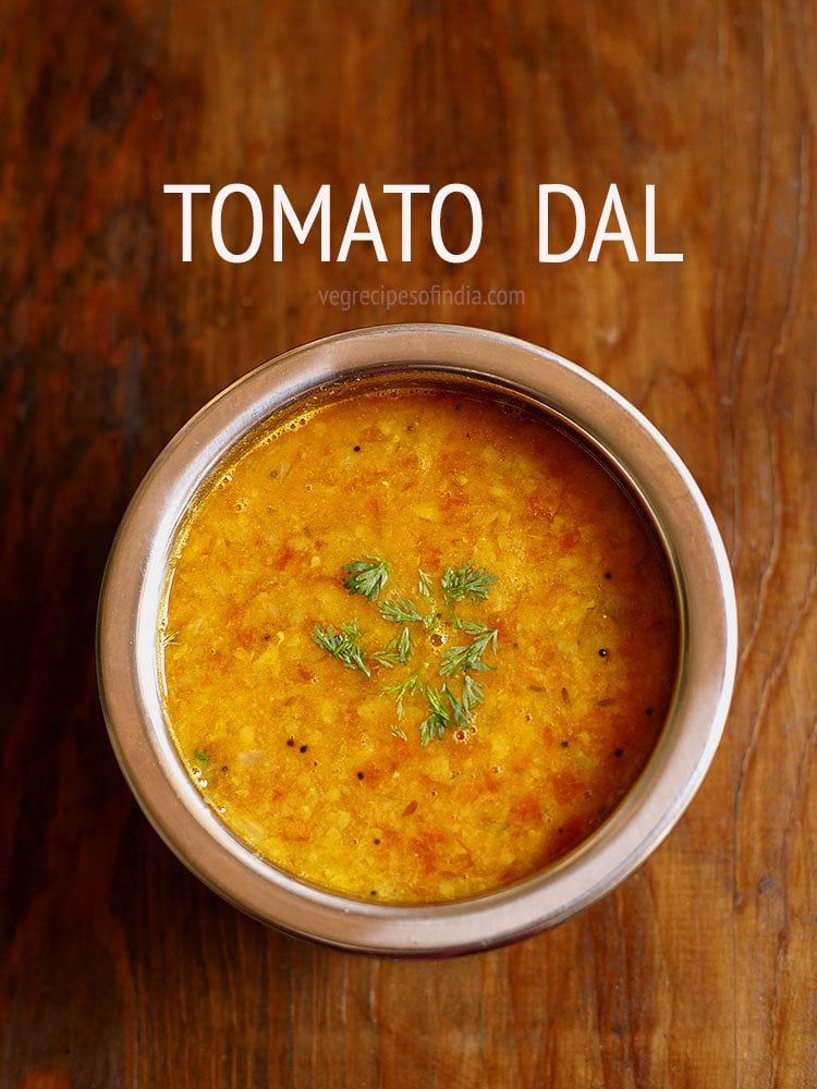 tomato pappu garnished with coriander leaves and served in a bowl with text layover.