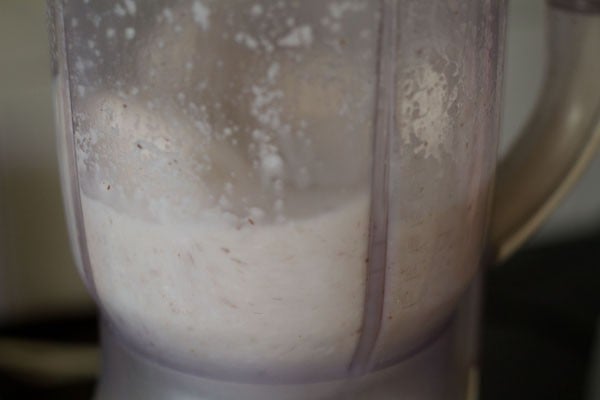 blending grated coconut with water. 