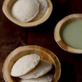 leftover rice idli served in wooden bowls with coconut chutney in one of the bowls kept on the side.