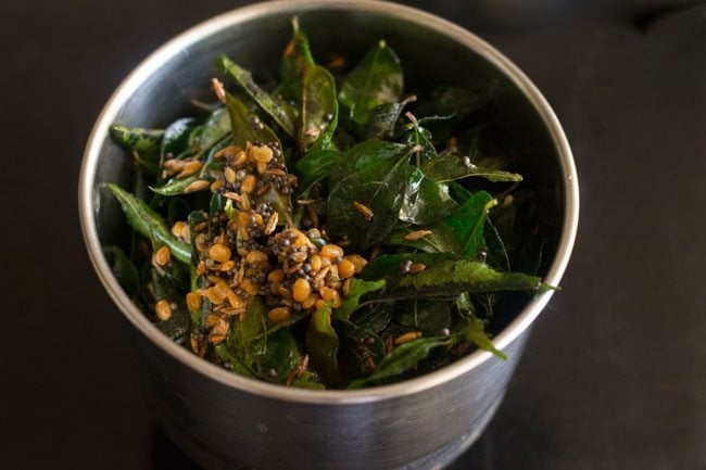 fried curry leaves, salt and water added in a grinder jar. 