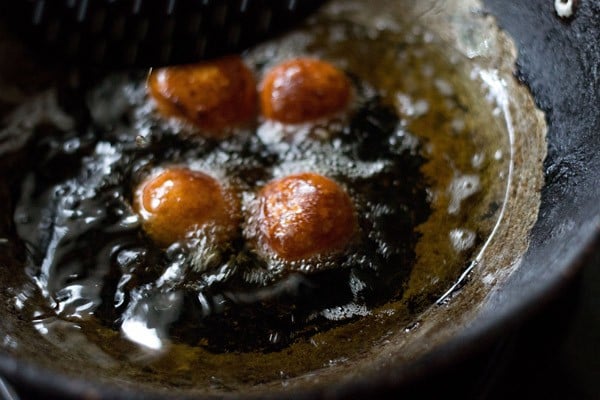 frying gulab jamun till golden.