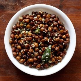 top shot of Black Channa Sundal served in a white bowl on a wooden table.