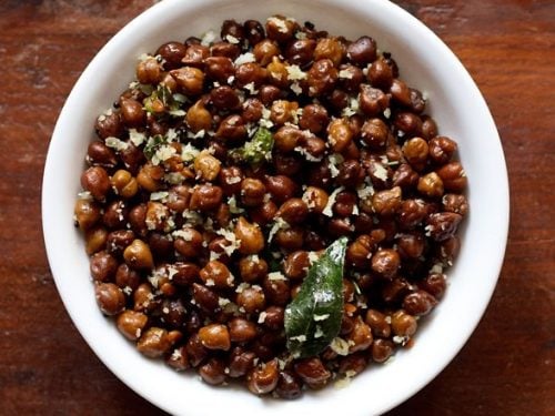 top shot of Black Channa Sundal served in a white bowl on a wooden table.