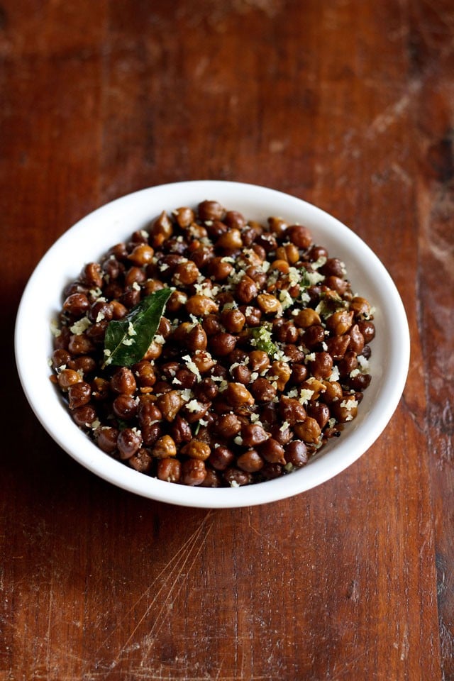 top shot of Black Channa Sundal or Kondakadalai Sundal served in a white bowl on a wooden table.