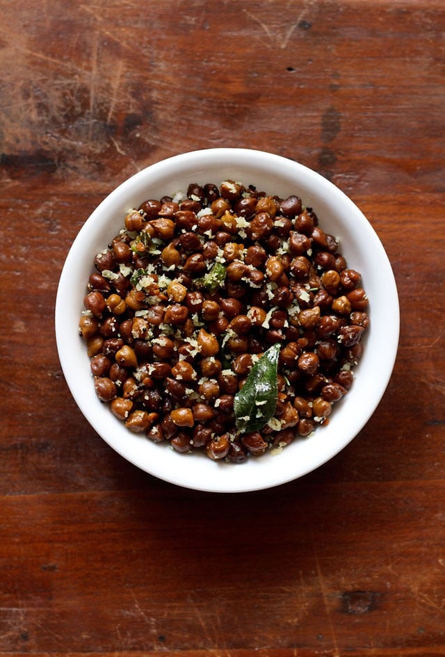 top shot of Black Channa Sundal or Kondakadalai Sundal served in a white bowl on a wooden table.