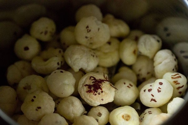 makhana and cardamom in a grinder jar