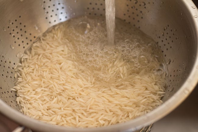 Rinse rice in a colander