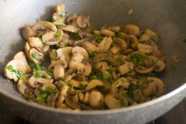 stir frying mushrooms for a minute