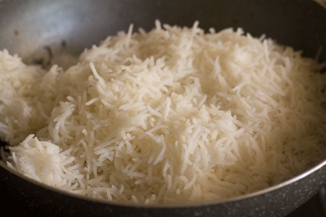 add cooked rice to mushrooms in the pan