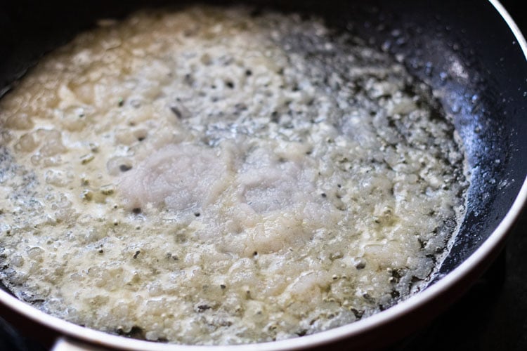 pasta de cebolla añadida en aceite caliente en una sartén