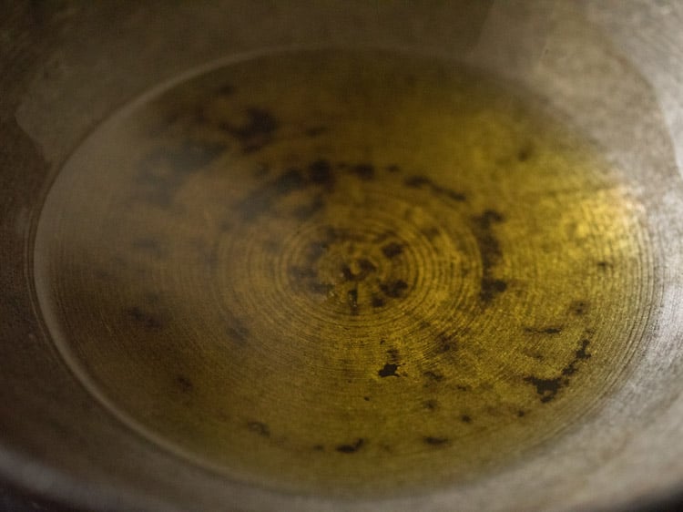 melted ghee in the kadai for rava kesari recipe.