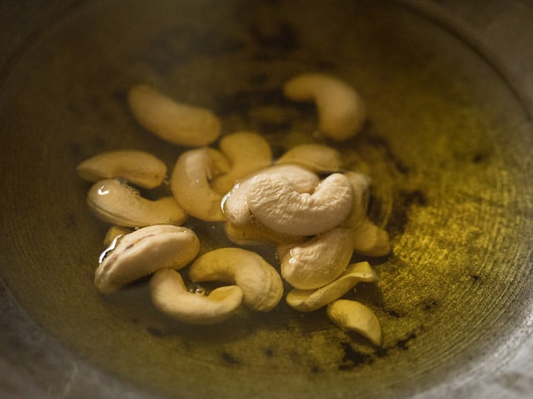 cashews added to ghee for rava kesari recipe.