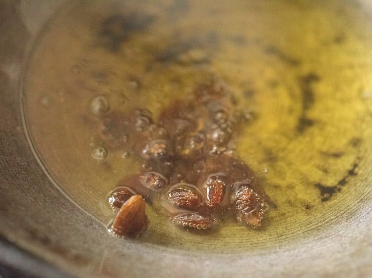 raisins added to ghee for rava kesari recipe.