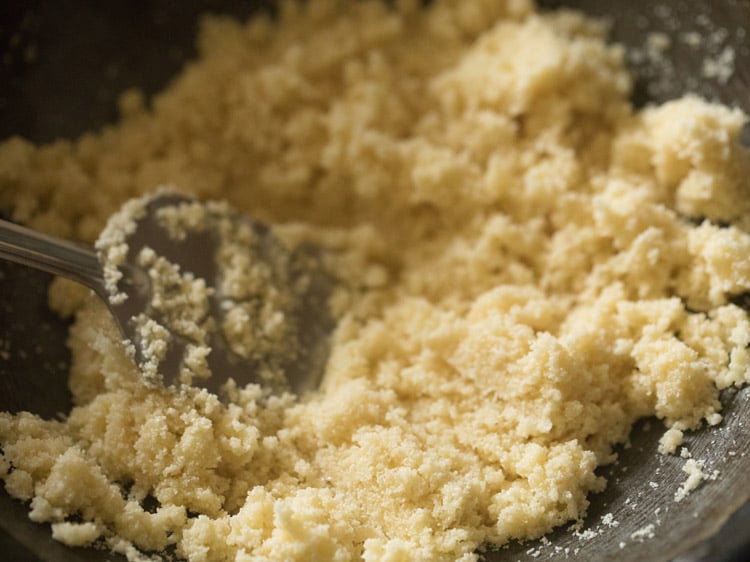 roasting rava in hot ghee for rava kesari recipe.