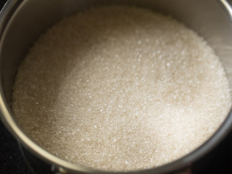 sugar in a pan to make sugar syrup for rava kesari recipe. 