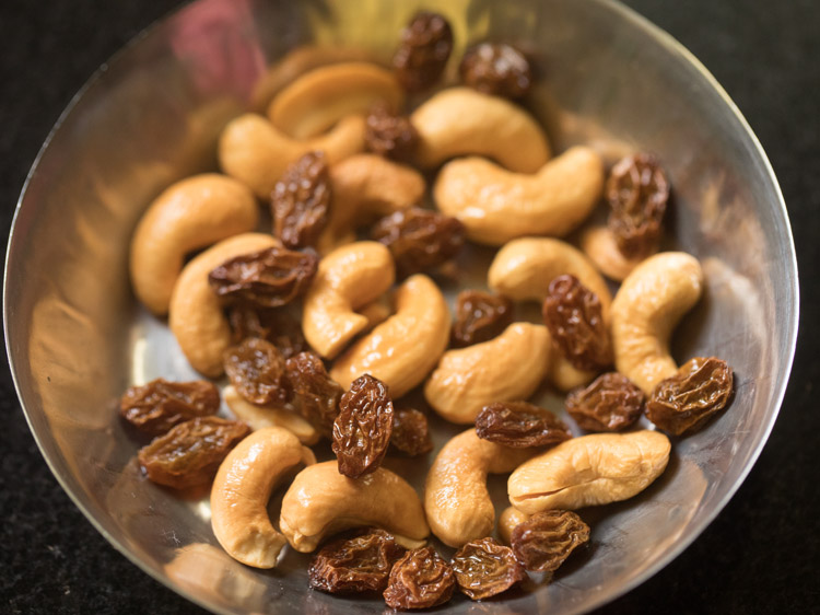 fried cashews and raisins in the plate for rava kesari recipe. 