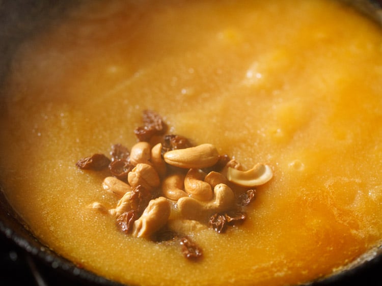 fried cashews and raisins added to kesari recipe mixture.