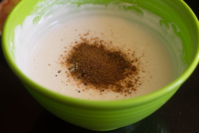 roasted cumin powder added to whisked curd for making vegetable raita. 