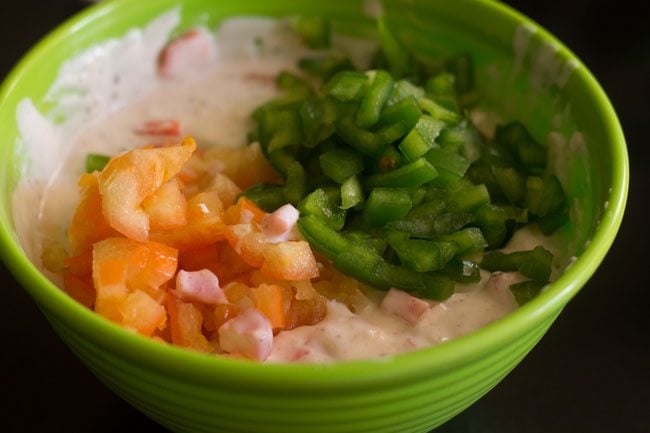 finely chopped tomato and finely chopped capsicum added to curd mixture. 