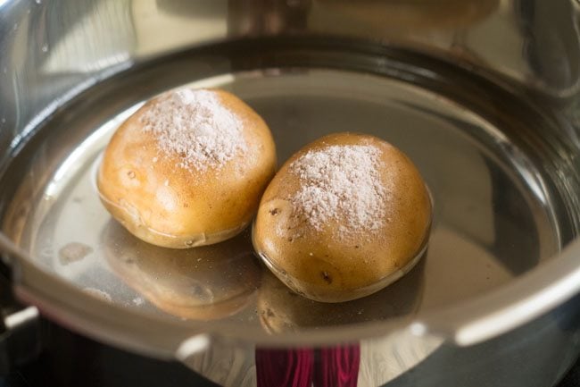 boiling potatoes with rock salt in water.