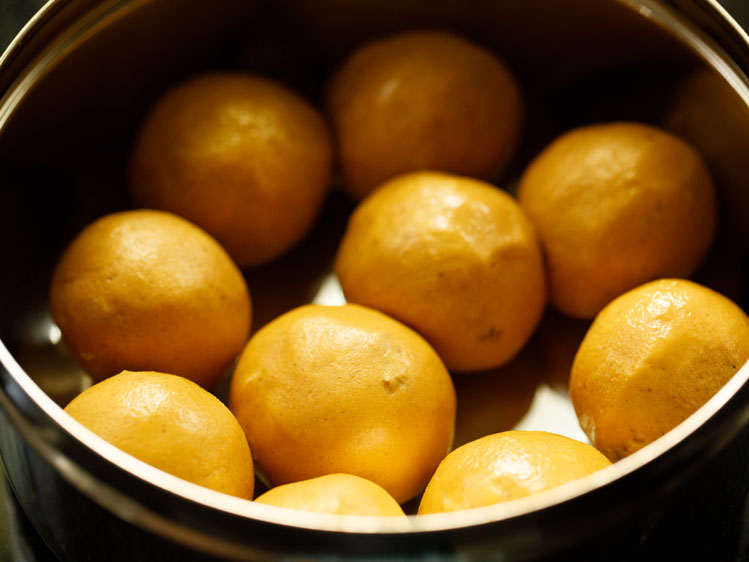 besan ke laddu placed in a steel container