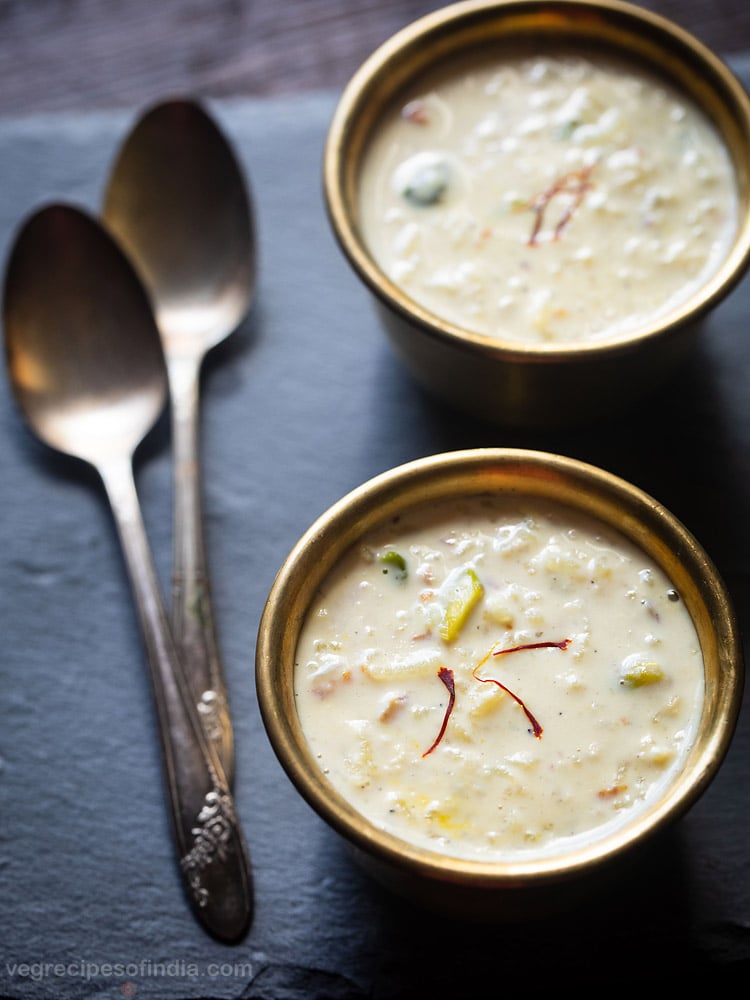 kheer served in individual bowls with 2 spoons kept on the left side and text layover. 