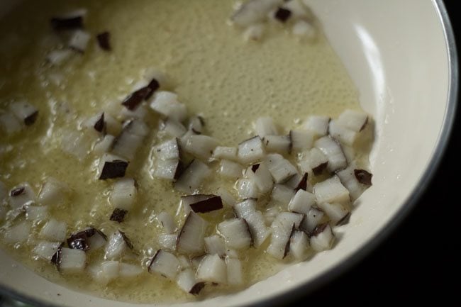 frying chopped coconut in ghee for tempering 