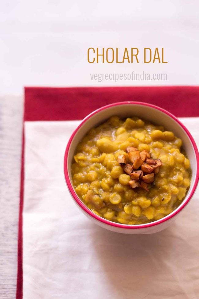 cholar dal in a bowl topped with fried coconut