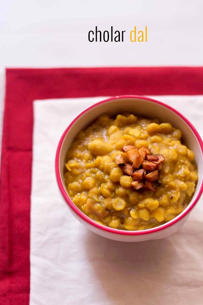 cholar dal served in a bowl garnished with fried coconut 