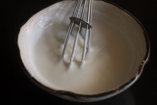 whisking sugar with curd. 