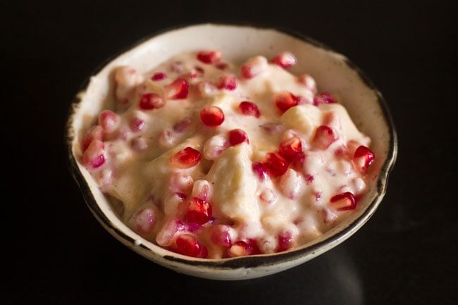 fruits mixed well in the whisked spiced yogurt. 