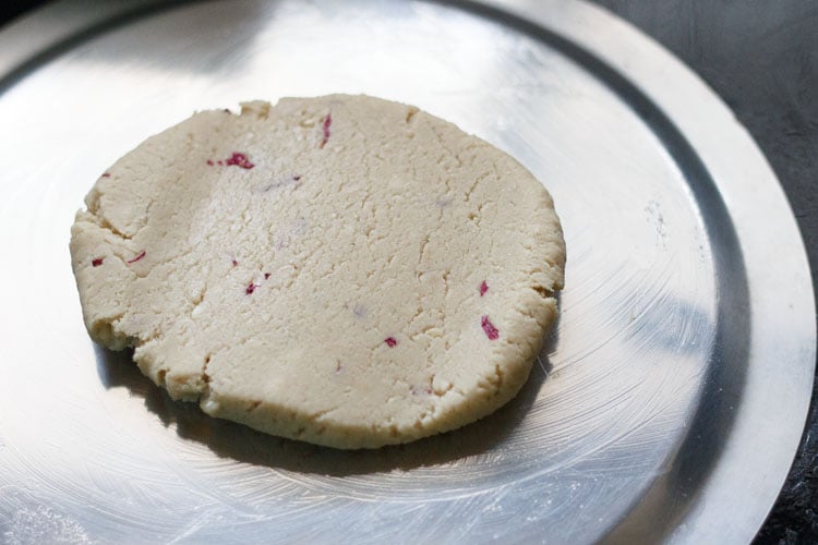 cashew dough flattened on a greased plate