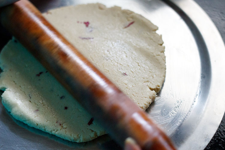 rolling the cashew dough with rolling pin