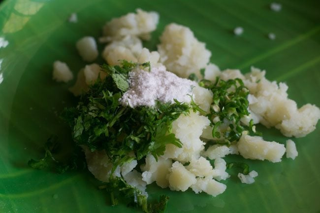 mixing potato coriander leaves green chili and salt