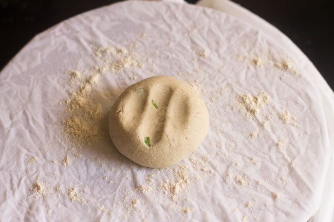 flattened dough ball on moist cloth