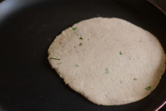 rolled kuttu ka paratha placed on tawa