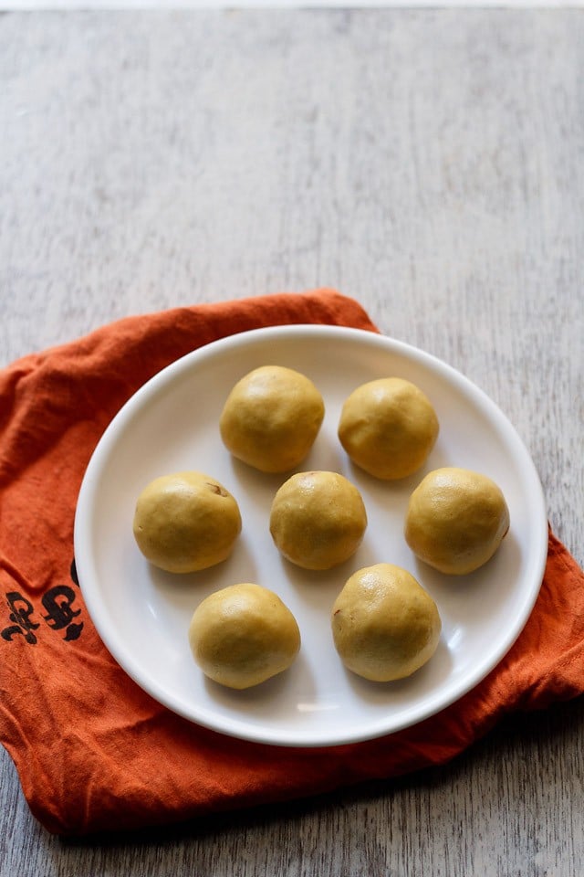 maladu served on a white plate kept on a rust colored cloth. 