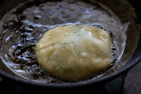 puffed up koraishutir kochuri in hot oil.