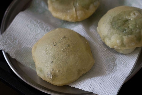 fried koraishutir kochuri on kitchen paper towel.