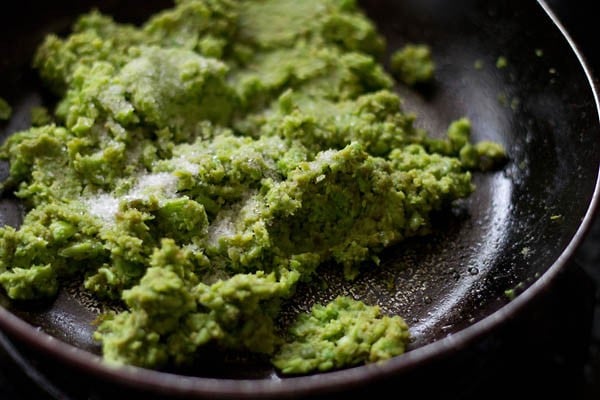 ground peas paste, suagr and salt added to the pan.