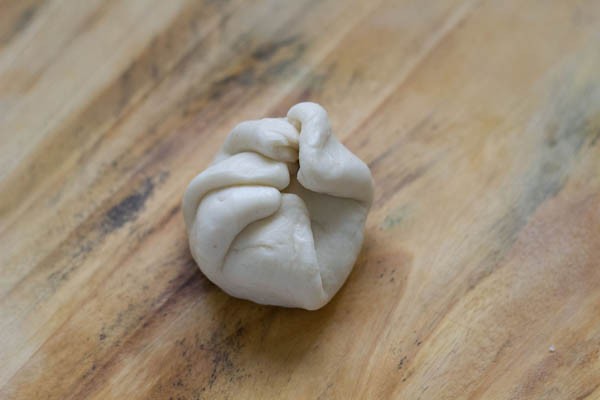 edges gathered, brought in the center and joined.