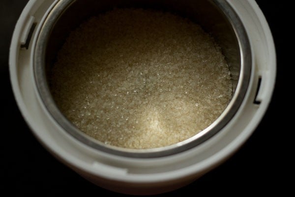 top shot of sugar in a mixer-grinder jar.