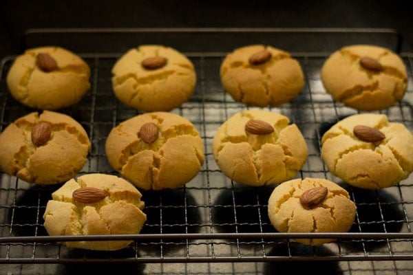 top shot baked nankhatai sitting on wire cooling rack.