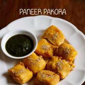 paneer pakora served in a white plate with green chutney in a small white bowl