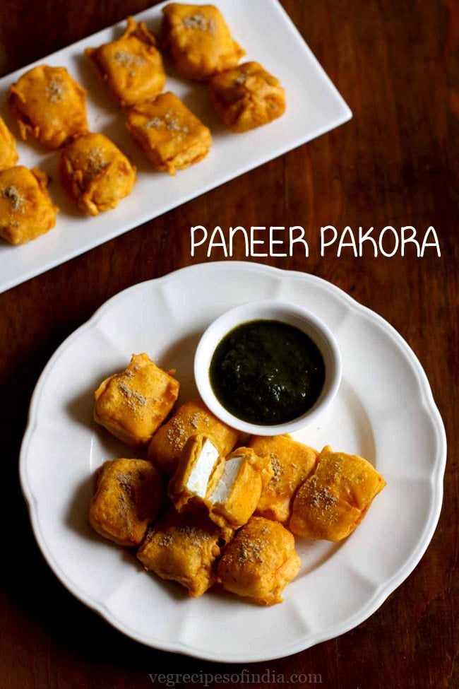 paneer pakora served in a white plate with green chutney in a small white bowl