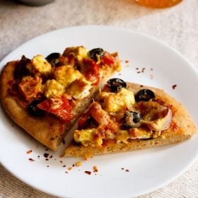 paneer tikka pizza wedges served on a white plate.