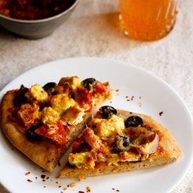 paneer tikka pizza wedges served on a white plate.