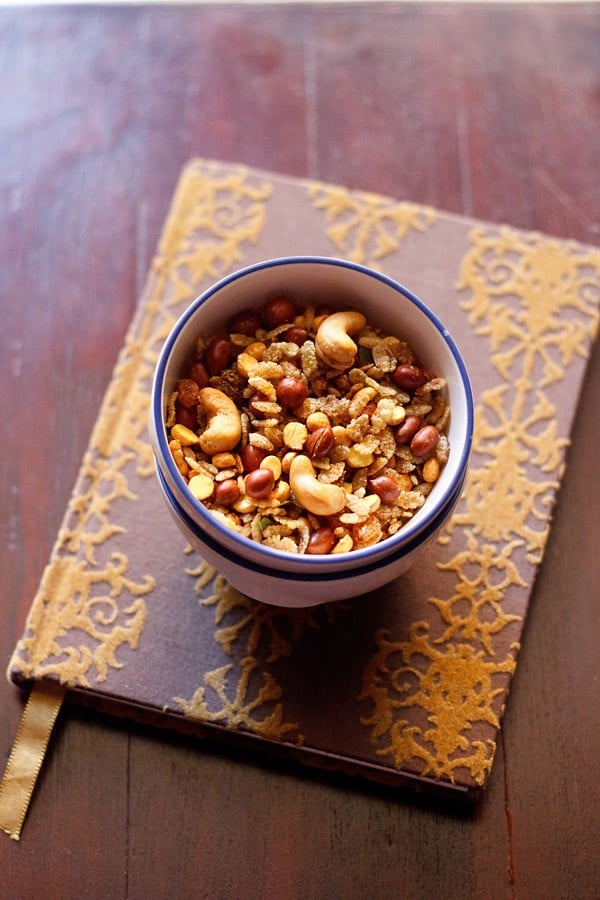 chivda in a blue rimmed bowl kept on a designed diary book