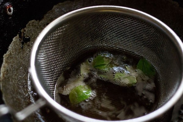curry leaves frying in oil